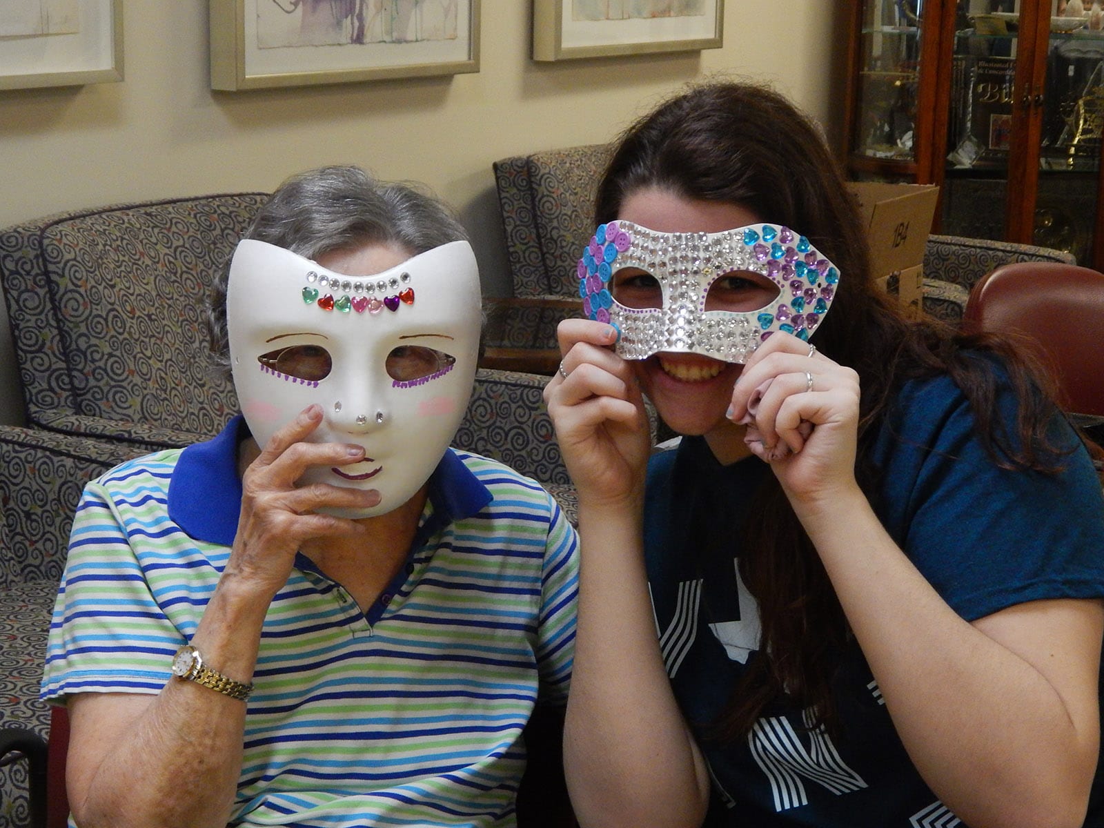 Medallion resident with student helper making Purim masks 2